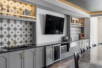 Second-story club area with kitchenette and tvs